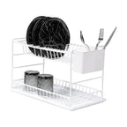 White two-tier dish rack holding black plates, glasses and cutlery