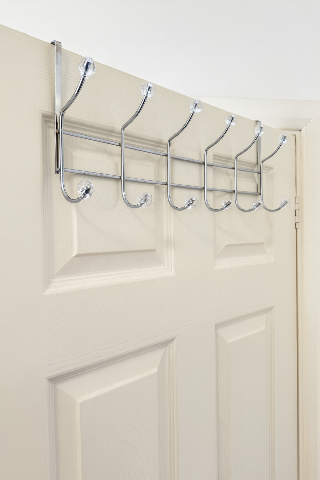 Chrome hook rail fitted over the top of a white door