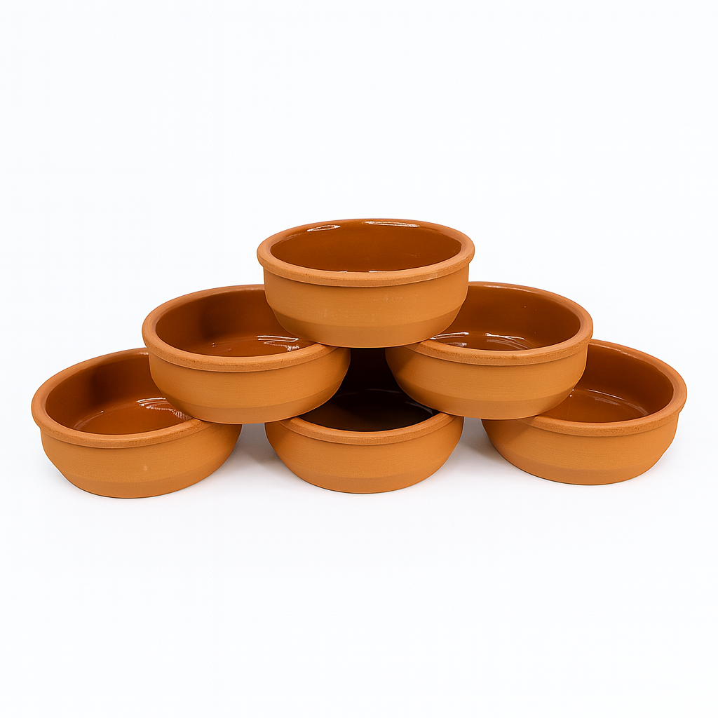 Six small terracotta tapas dishes arranged in a pyramid